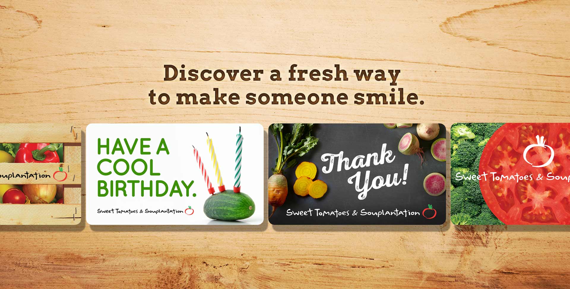 An array of Garden Fresh gift cards on a wood grain background, with the text, 
